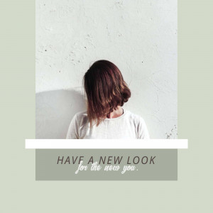 Woman with short hair against a textured wall with text 'Have a new look for the new you'.
