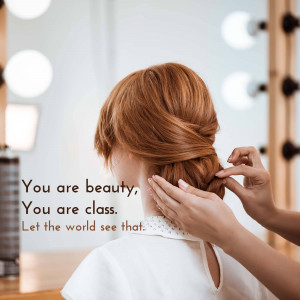 A hairstylist working on a woman's red hair in a salon, with motivational text overlay.