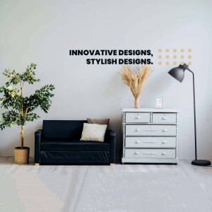 A stylish living room interior with a dark sofa, gray dresser, and decorative plants.