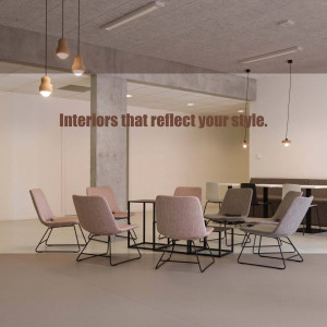 A modern office waiting area with comfortable chairs and warm lighting.