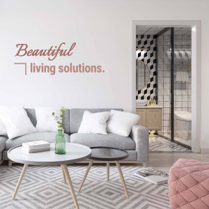 A stylish and modern living room with a gray sectional sofa and a glimpse into a contemporary bathroom.