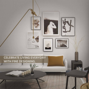 A stylish and minimalist living room with artwork and a comfortable sofa.