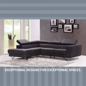 A stylish black sectional sofa in a modern living room setting with a gallery wall.