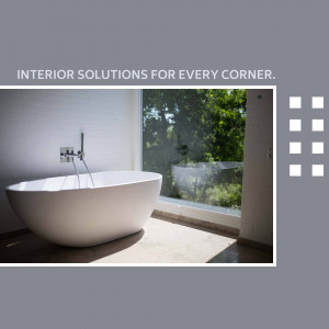 A modern bathroom with a freestanding bathtub in front of a large window.