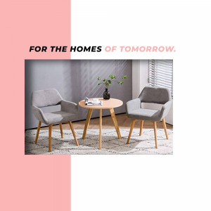 Two grey armchairs and a small round table in a modern living room setting.