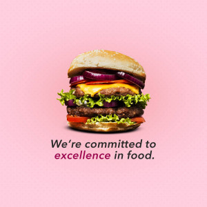 A close-up of a juicy burger with fresh ingredients on a pink background.