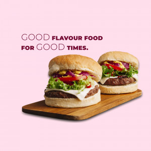 Two juicy burgers on a wooden serving board with the text 'Good Flavour Food for Good Times'