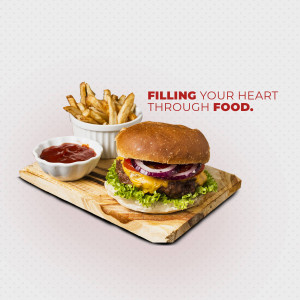 A close-up of a classic cheeseburger with fries and ketchup on a wooden serving board.