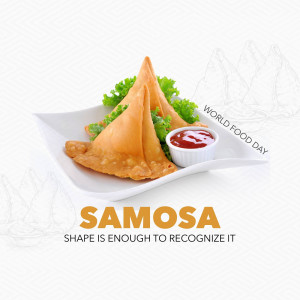 Close-up of two golden-brown samosas with lettuce and a side of ketchup on a white plate.