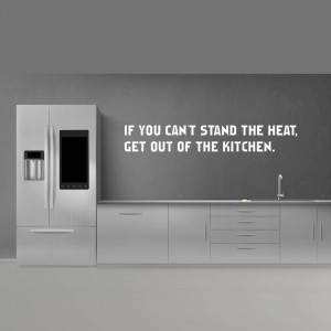 Modern kitchen with a motivational quote on the wall.