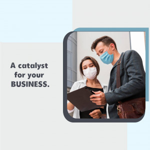 Two business professionals wearing face masks discussing documents.