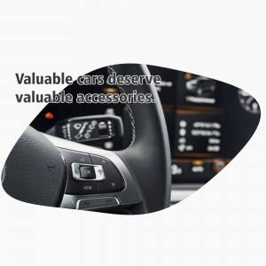 Close-up of a car side mirror with integrated control panel and steering wheel details.