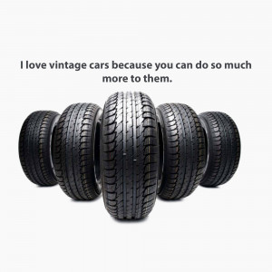 Stack of black vintage car tires against a white background