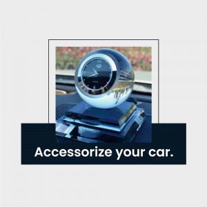 A glass globe clock sitting on a black base on a car dashboard.