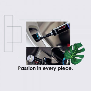 Close-up of a digital tire pressure gauge being used on a car tire with a tropical leaf in the background.