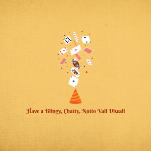 Playing cards exploding from a firecracker with Diwali greeting