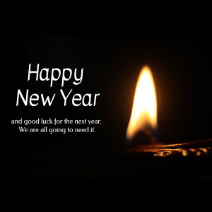 Candle lit with 'Happy New Year' text