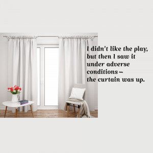 Interior scene with white curtains, a chair, and a small table with a book and flowers.