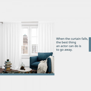 Interior shot of a comfortable armchair near a window with a city view and a stack of books.