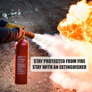 A person using a fire extinguisher to put out a fire.