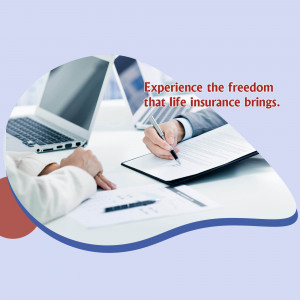 Person writing in a notebook with laptops and financial documents, promoting life insurance.