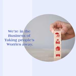 Wooden blocks depicting life's essentials - home, family, car, and umbrella - being held by a hand, symbolizing insurance protection.