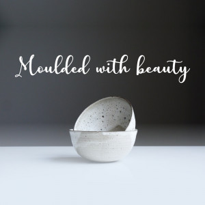 Stack of three speckled ceramic bowls on a grey surface with text overlay.