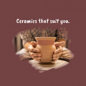 Hands holding a pottery vase on a pottery wheel