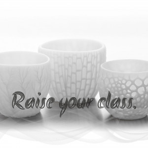 Three white ceramic tea cups with textured designs and the text 'Raise your class'.