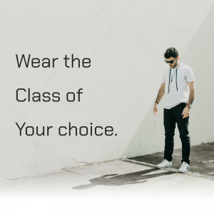 Man in white t-shirt and black pants leaning against a white wall with text overlay.