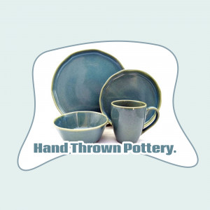 A set of hand-thrown pottery including plates, bowls, and mugs in shades of blue and teal.
