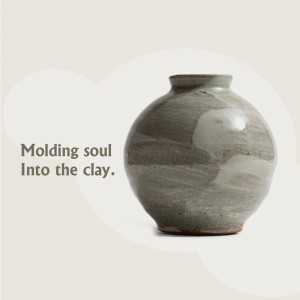 A rustic clay pot with a unique glaze and a soft, blurred background.