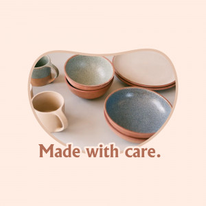 A collection of handmade ceramic bowls and a mug in earthy tones.