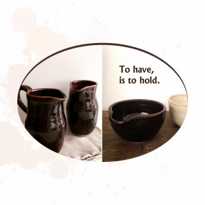 Two dark brown ceramic pitchers and a small bowl on a linen cloth