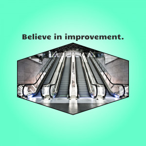 Hexagonal frame around an escalator in a subway station with the text 'Believe in improvement.'
