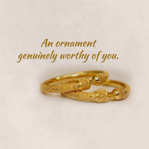 Close-up of a textured golden bangle with text overlay