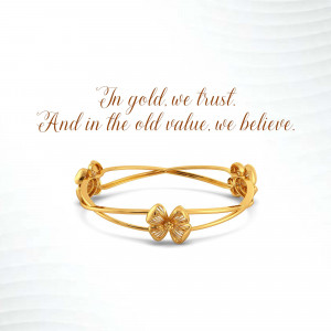 Close-up of a delicate gold bracelet with a floral design.