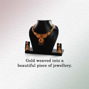 Close-up of a gold necklace and earring set on a black jewelry bust.