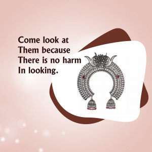 Close-up of ornate silver earrings with red gemstones on a pastel background.