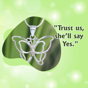 Close-up of a silver butterfly pendant with the quote 'Trust us, she'll say Yes.'