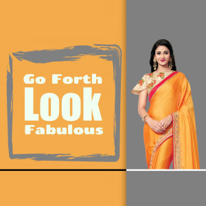 Woman wearing a vibrant orange and gold saree with embroidered blouse