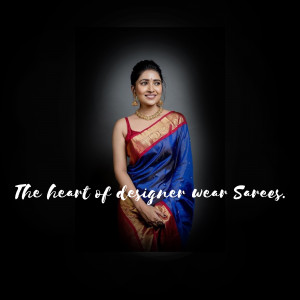 Portrait of a woman wearing a beautiful blue and red saree with gold jewelry.