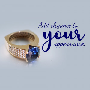 Close-up of a gold ring with a large blue sapphire gemstone and diamond accents.