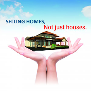 Hands holding a house representing real estate services