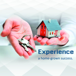 Hands holding keys and a miniature house representing homeownership and real estate success.