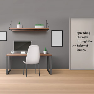 A minimalist home office with a wooden desk, chair, and floating shelf against a gray wall.