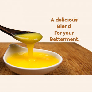 Close-up of golden ghee being poured from a spoon into a small white bowl.