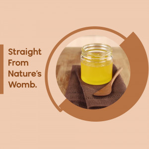 A jar of golden honey with a wooden spoon on a brown cloth, with a peach-colored background and text 'Straight From Nature's Womb'.