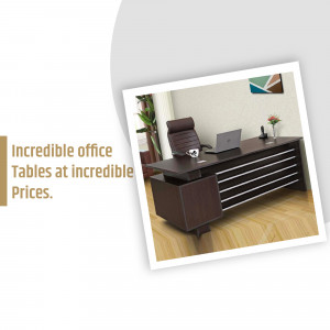 A stylish dark wood office desk with a black leather chair and laptop.