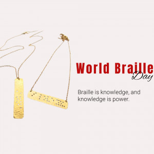 Close-up of two gold necklaces with Braille pendants against a pale pink background, celebrating World Braille Day.